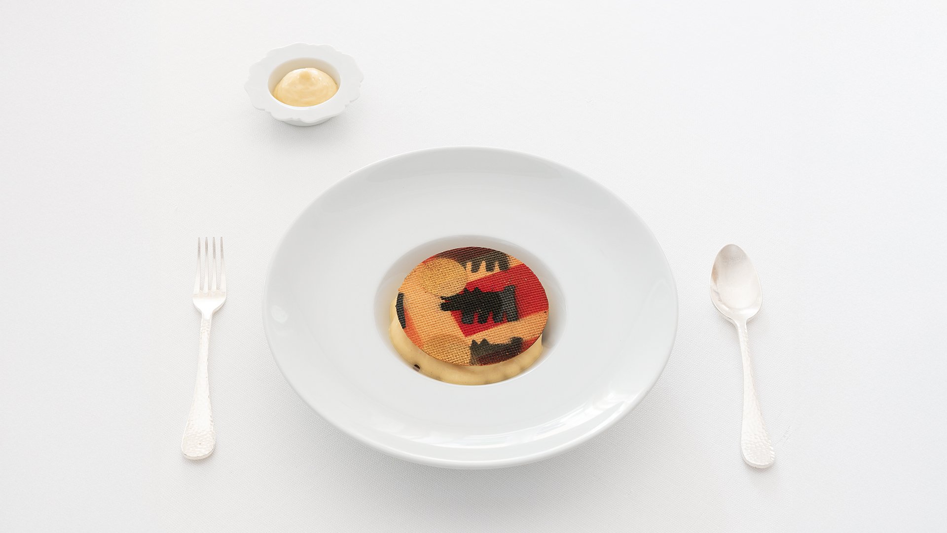 Artistic dish with decorated wafer and cream, served on an elegant white plate