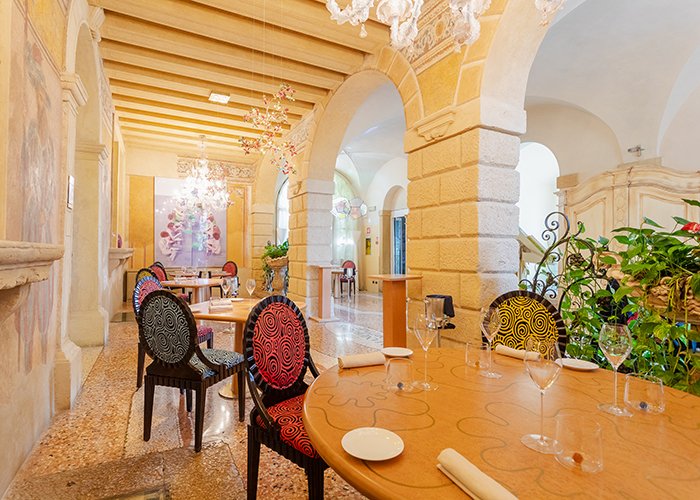 Dining room with artistic chairs and wall frescoes