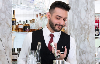 Peter’s Bar bartender serving an elegant cocktail at the hotel
