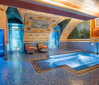 Main spa room with hydromassage pool and vaulted painted ceiling